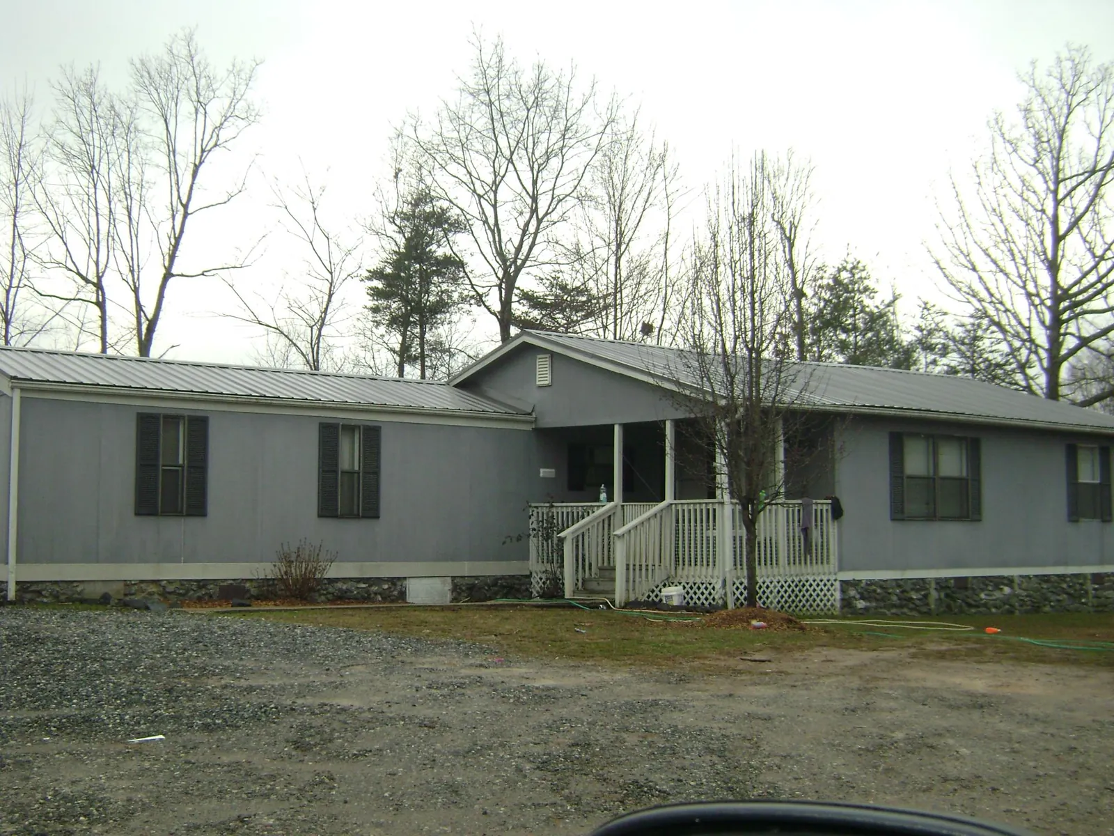 Metal roof over a manufactured home with a covered front porch in Riverton